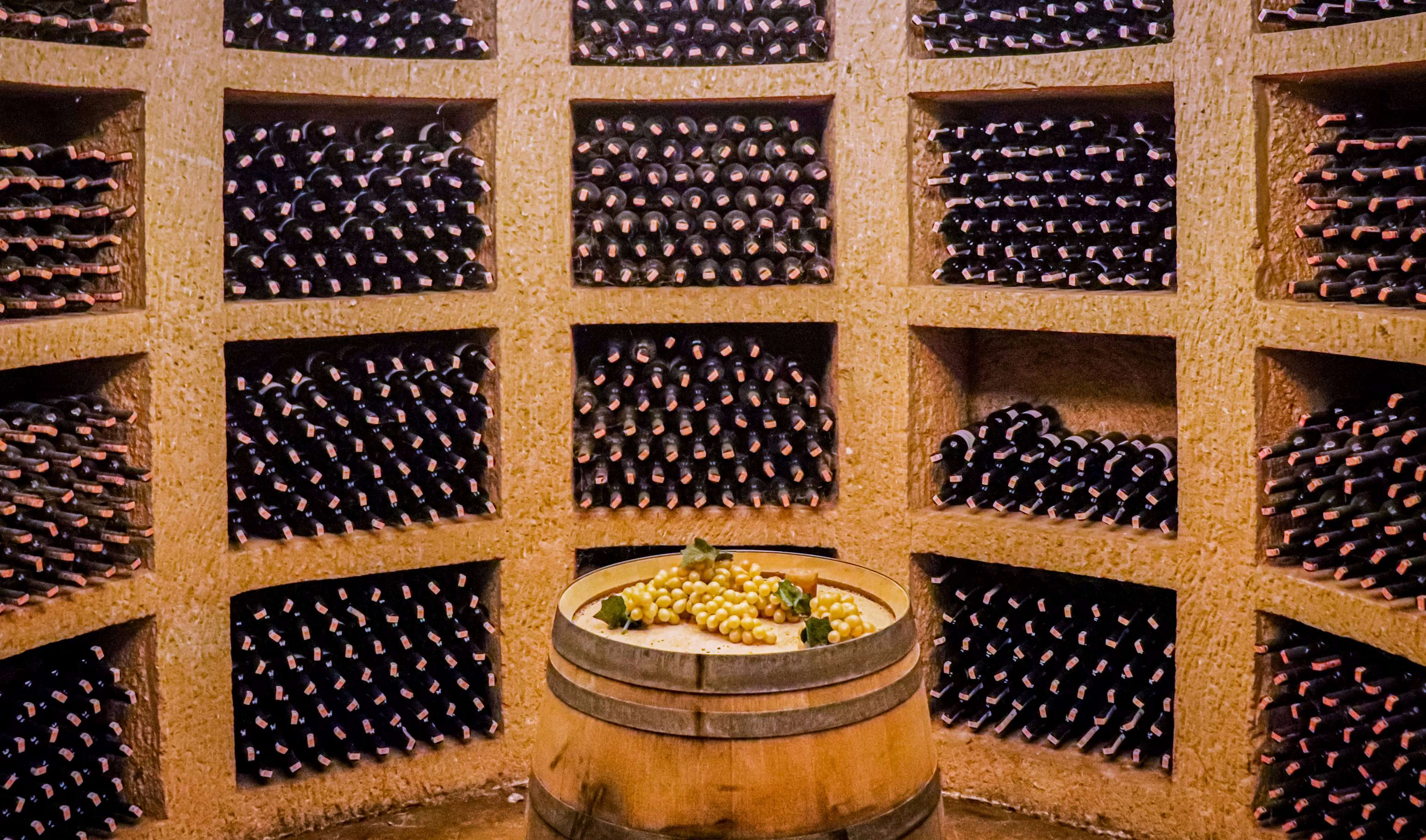 Cellar storage with structured bottle aging and grapes on barrel